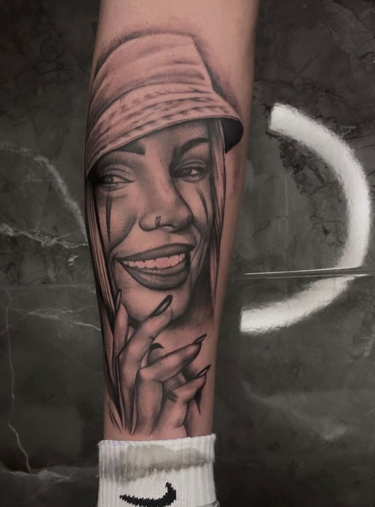 Chicana with bucket hat forearm