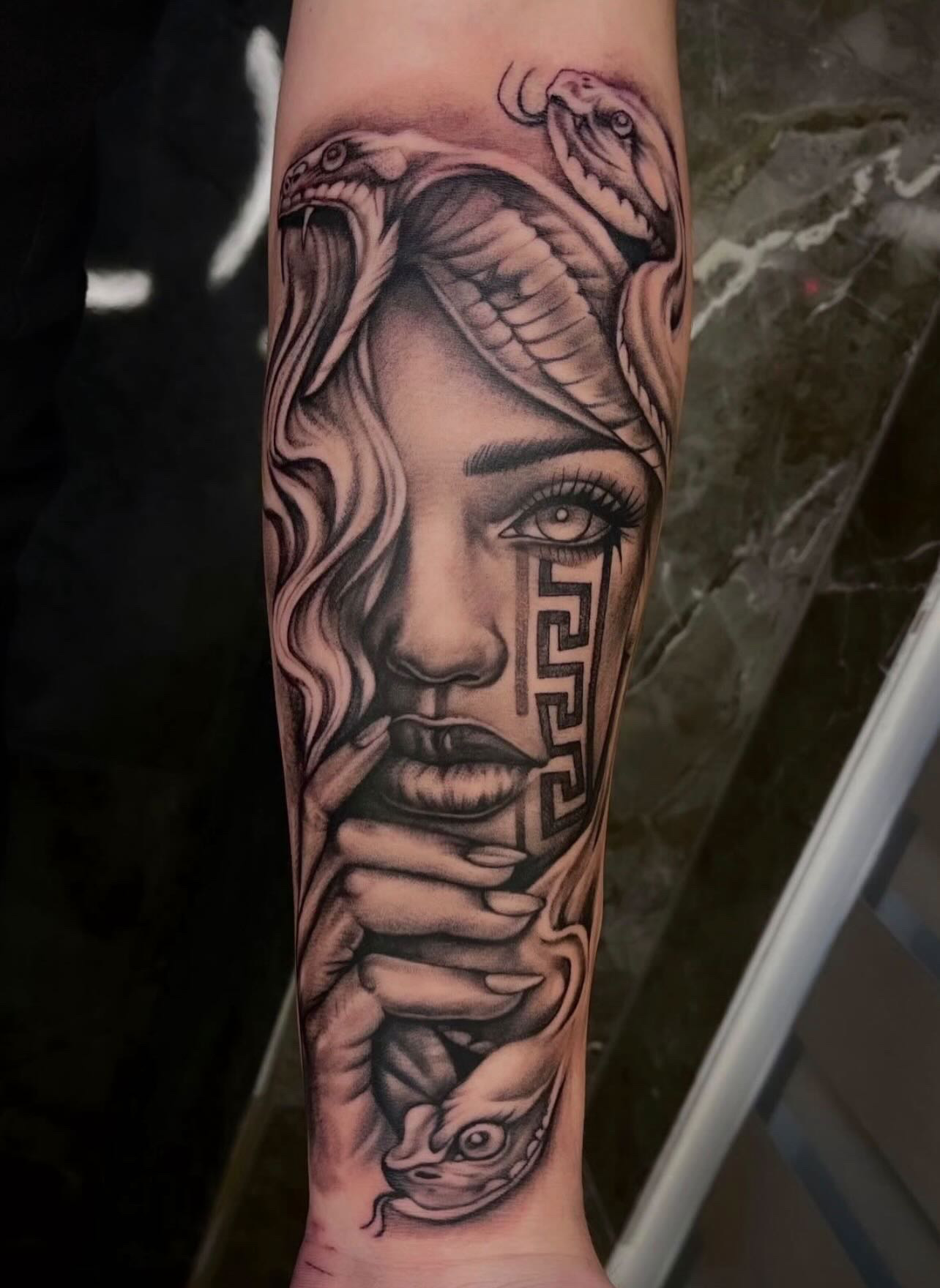 Medusa face with snakes & Greek meander